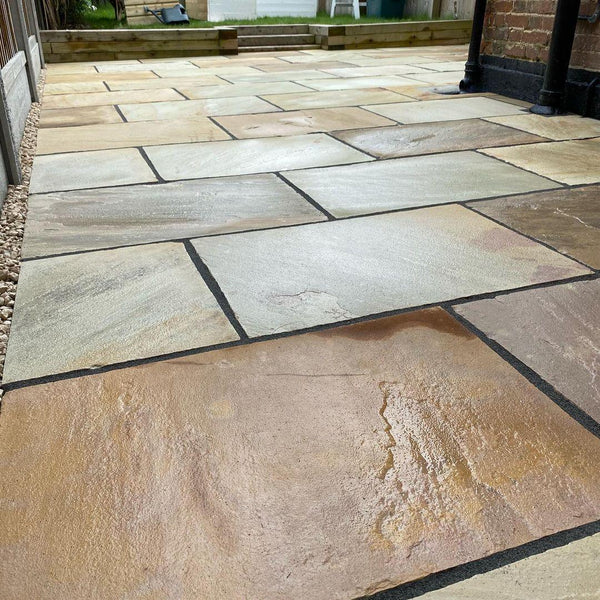 Mint Fossil Patio Slabs β hand-cut sandstone with riven texture and subtle fossil details.