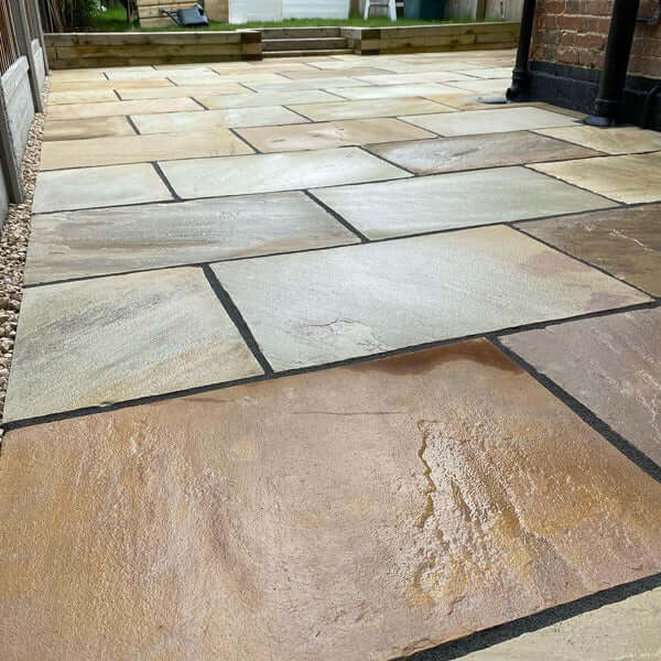 Mint Fossil Patio Slabs β hand-cut sandstone with riven texture and subtle fossil details.