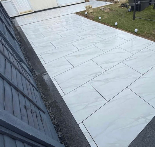 Statuario Marble Porcelain Paving Slabs β luxurious white marble-effect porcelain tiles with subtle grey veining, ideal for elegant and modern outdoor patios
