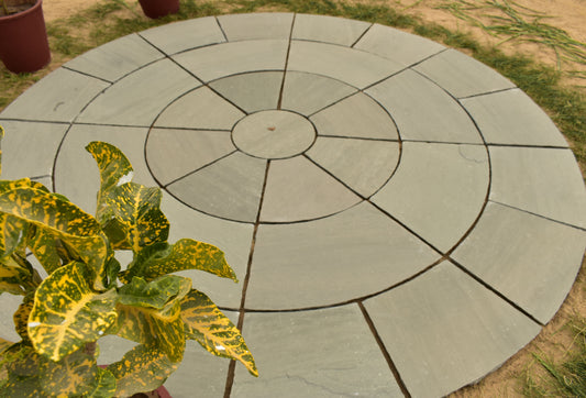 Kandla Grey circular paving stone with a smooth sandstone finish and cool grey tones, perfect for modern outdoor spaces.