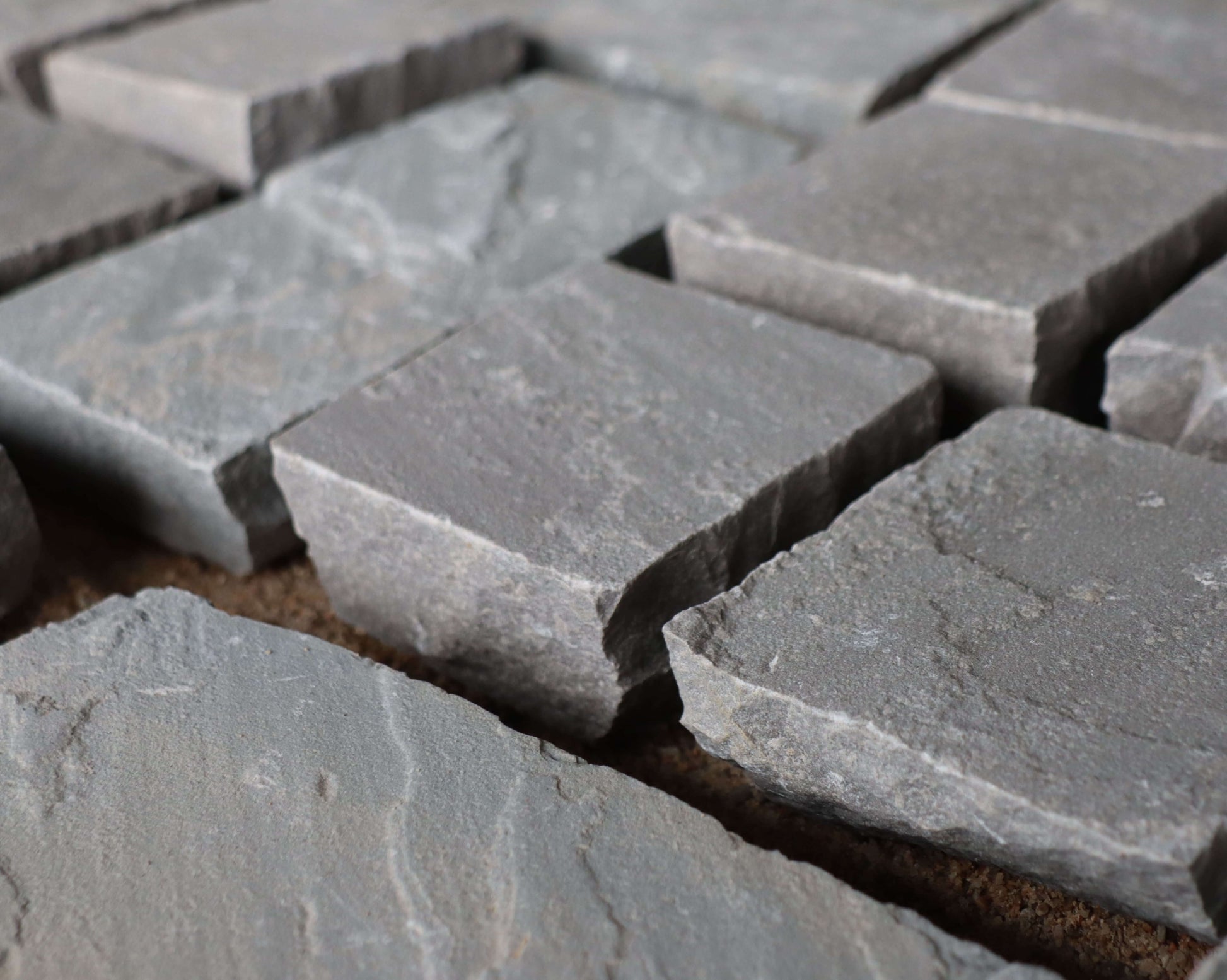Kandla Grey cobblestones with rugged texture and natural grey shades, ideal for driveways, pathways, and rustic landscapes.