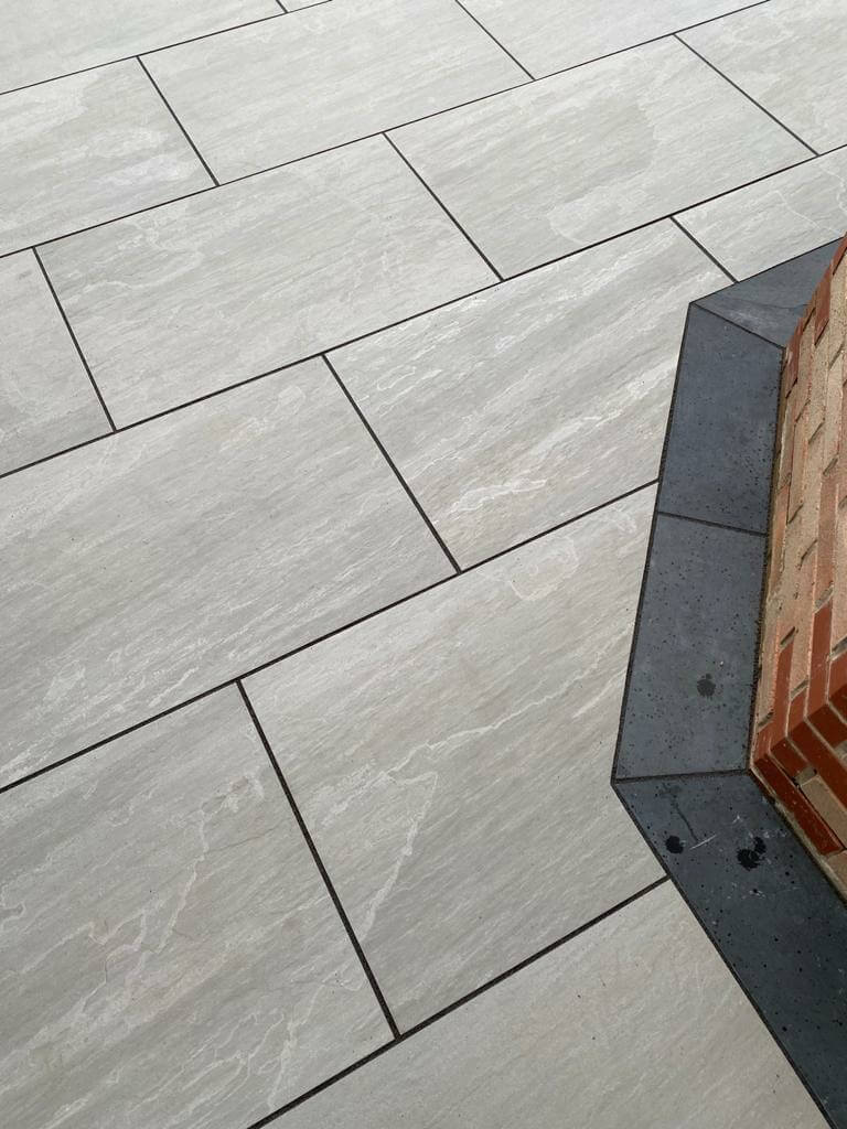 Lakestone Grey paver slabs with soft grey hues and a natural riven texture, perfect for stylish patios and garden pathways.
